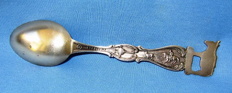 Souvenir Mining Spoon Little Jonny Mine Leadville reverse.JPG - SOUVENIR MINING SPOON LITTLE JONNY MINE LEADVILLE COLORADO - Sterling silver spoon, 5 9/16 in. long, embossed mining scene in bowl with marking LITTLE JONNY MINE LEADVILLE, COLO., front & back of the handle are decorative with a mule, miner and pick axes, marking COLORADO on handle, ca. 1900, back with sterling marking and hallmark H in a circle, weight 21 gms  [Leadville CO is the highest incorporated city in the United States. A former silver mining town that lies near the headwaters of the Arkansas River in the heart of the Rocky Mountains, the city includes the Leadville Historic District, which preserves many historic structures and sites from Leadville's dynamic mining era. Gold was discovered in the area in late 1859, during the Pike's Peak Gold Rush. However the initial discovery, where California Gulch empties into the Arkansas River, was not rich enough to cause excitement. On April 26, 1860, Abe Lee made a rich discovery of placer gold in California Gulch, about a mile east of Leadville, and Oro City was founded at the new diggings.  By July 1860, the town and surrounding area had a population of 10,000 and an estimated $2 million in gold was taken out of California Gulch and nearby Iowa Gulch by the end of the first summer. Within a few years the richest part of the placers had been exhausted, and the population of Oro City dwindled to only several hundred.   However, in 1874 gold miners at Oro City discovered that the heavy sand that impeded their gold recovery was the lead mineral cerussite that carried a high content of silver. Prospectors traced the cerussite to its source, and by 1876, had discovered several lode silver-lead deposits. A number of silver mines were established on Iron Hill and Carbonate Hill, east of town.  The city of Leadville was founded near the new silver deposits in 1877 by mine owners Horace Austin Warner Tabor and August Meyer, setting off the Colorado Silver Boom. By 1880, Leadville was one of the world's largest silver camps, with a population of over 40,000. The city's fortunes declined with the repeal of the Sherman Silver Purchase Act in 1893 which resulted in a drop in the price of silver.  The Little Jonny was probably Leadville's richest mine.  It also established two of the biggest names in Colorado mining, John F. Campion and James J. Brown.  Campion was born in Prince Edward Island, Canada and moved with his parents to California in 1862.  He began his mining career as a prospector in California and Nevada and at the age of 20 discovered the White Pine silver mine.  He owned and developed the Pioche-Phoenix Mining Company in Nevada.  In 1879, Campion transferred his activity to booming Leadville, Colorado, where he formed the Iron Hill Consolidated Mining Company, owning and developing a number of producing properties designated by animal names.  Among these were the Bison, Reindeer, Elk, and, most famously, the Ibex, which came to include the prolific Little Jonny mine.  The Little Jonny was developed in 1879 but by 1890 the mine seemed to be playing out.  After Campion acquired the Little Jonny in 1890, consolidating it into his Ibex property, he hired James J. Brown as superintendent of the Little Jonny and invested $30,000 to find more ore at the mine.  James J. Brown was born in 1854 in Waymart, PA the son of an Irish immigrant father and a schoolteacher mother.  His mother provided his education and he left home when he was 23 heading west to the placer mines of the Dakotas.  He ultimately ended up in Colorado after studying geology, ore deposits and mining techniques to become a better miner.  He married Margaret "Molly" Tobin Brown in 1886 and located in Leadville. At the Little Jonny, Brown timbered through notoriously unstable ground that had stopped earlier miners by devising a method of using baled hay and timbers to stop the cave-ins and discovered large deposits of high-grade gold-copper ore.  The grade of gold was so pure and the vein so wide that it was heralded as the then world's richest gold strike. Within a year, the Little Jonny was paying its investors $1 million per year and shipping 135 tons of gold ore per day.  Brown was awarded 12,500 shares or 12.5% of stock and a seat on the board. The mine became the largest gold mine in the Leadville district.  The Ibex Company and its owners John Campion, Byrd Page, A. V. Hunter and James Brown became extraordinarily wealthy.  In 1894 the Browns moved to Denver to spend their fabulous wealth.  His wife Molly Brown became quite famous as a survivor of the 1912 sinking of the RMS Titanic, the Unsinkable Molly Brown. After World War I, the mining industry in Leadville began to decline due to low world metal prices and other factors.  Ibex's Little Jonny Mine was one of the few mines that continued to operate throughout the Great Depression of the 1930s. The Denver and Rio Grande closed their Ibex Branch line in 1944. John Campion among other notable accomplishments went on to become a founder of the Denver Museum of Natural History (now the Denver Museum of Nature and Science) and the first President of its Board of Trustees.  He built a great collection of some 600 native gold specimens and donated the collection to the Museum, where his collection is now the core of one of the world’s premier collections of native gold.  As for Leadville, the last active mine in the district, the Black Cloud mine owned by ASARCO, closed in 1999.]